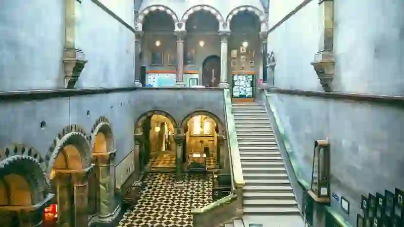 Grand staircase and arched columns inside the Museum Building at Trinity College Dublin.