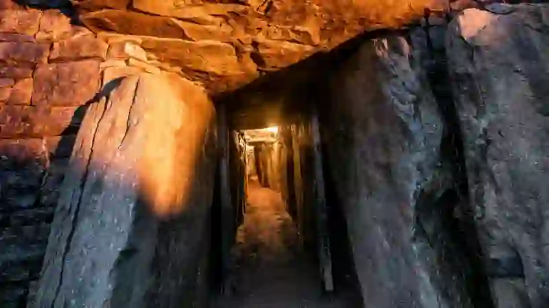 Entrance passage to Newgrange, County Meath, framed by large stones and lit from within.
