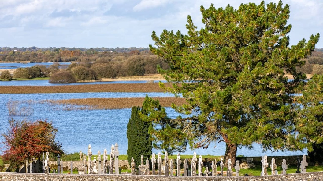 Clonmacnoise graveyard overlooking the River Shannon and surrounding wetlands in County Offaly, Ireland.