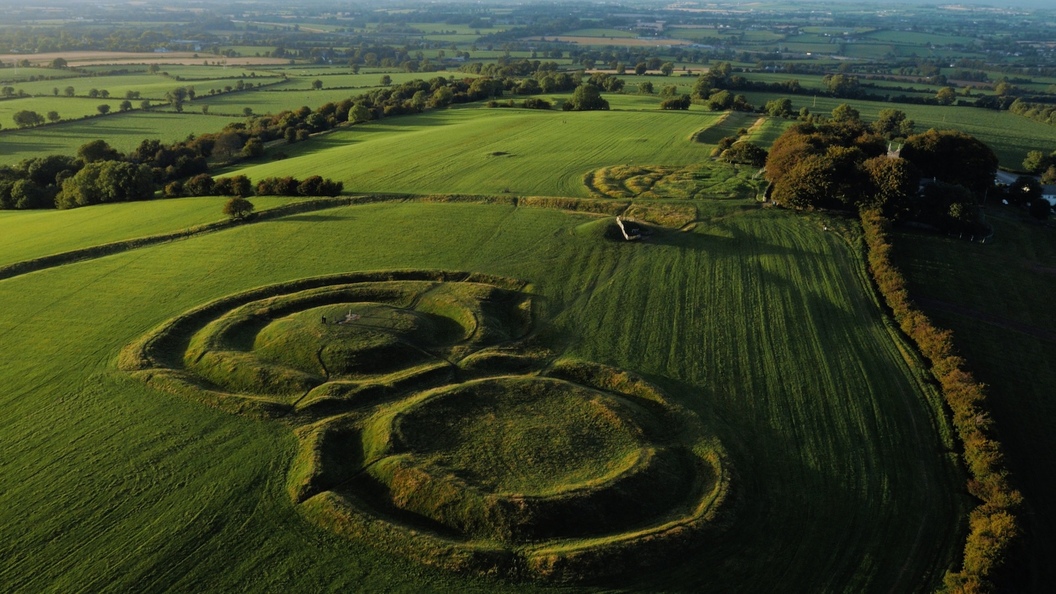 Aerial view of the Hill of Tara’s ancient ring forts and green pastures stretching across County Meath.