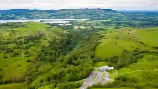 Aerial view of Marble Arch Caves, surrounded by green hills and countryside in Northern Ireland.