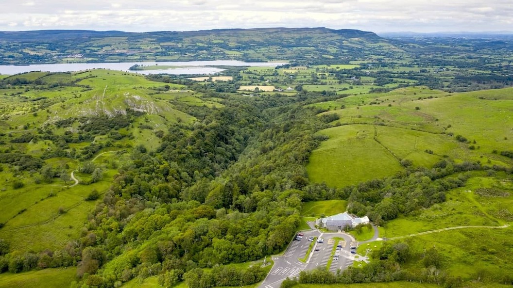 Aerial view of Marble Arch Caves, surrounded by green hills and countryside in Northern Ireland.