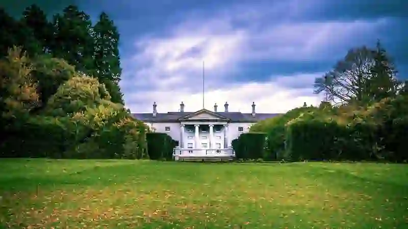 Áras an Uachtaráin framed by trees and lawns in Phoenix Park, official residence of the Irish President.