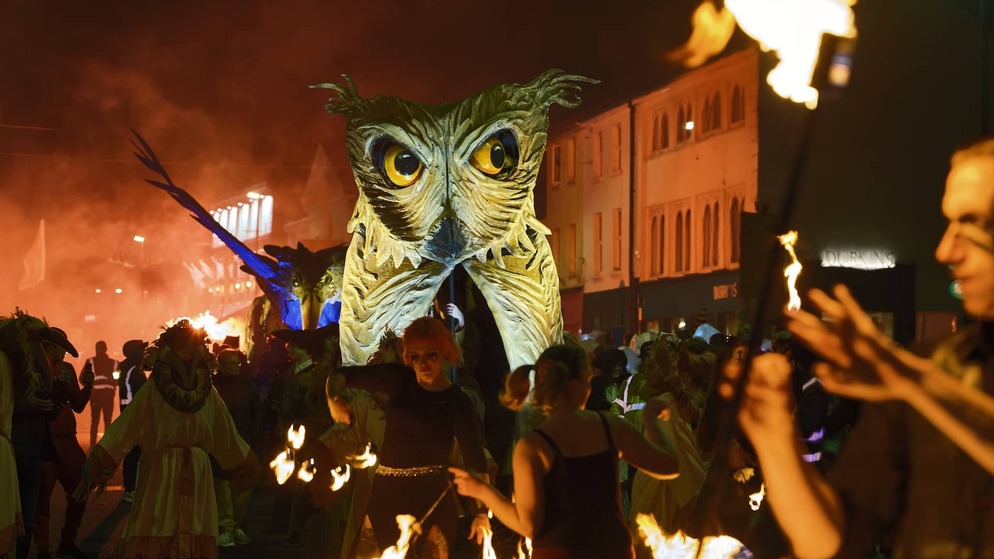 Fire performers surround a giant owl puppet at the Samhain Festival in Longford.