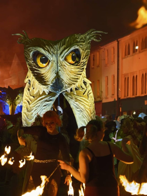 Fire performers surround a giant owl puppet at the Samhain Festival in Longford.