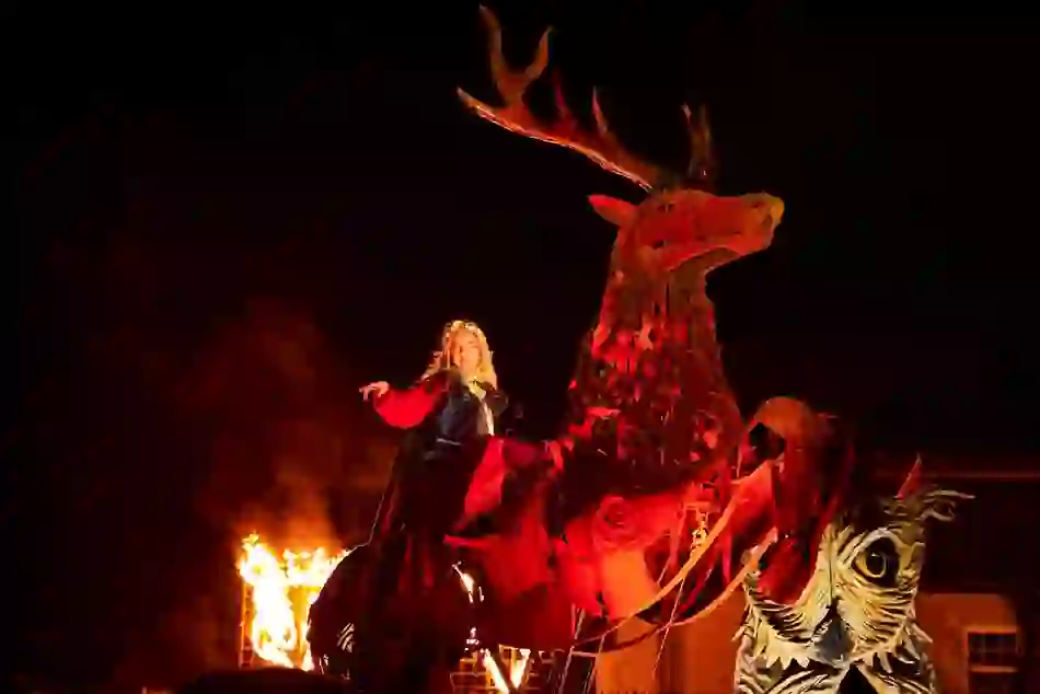 Performer on giant stag at Samhain Festival in County Longford, Ireland, with fire and smoke.