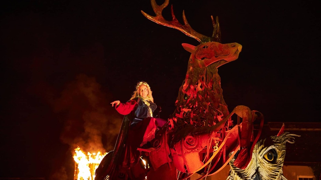 Performer on giant stag at Samhain Festival in County Longford, Ireland, with fire and smoke.