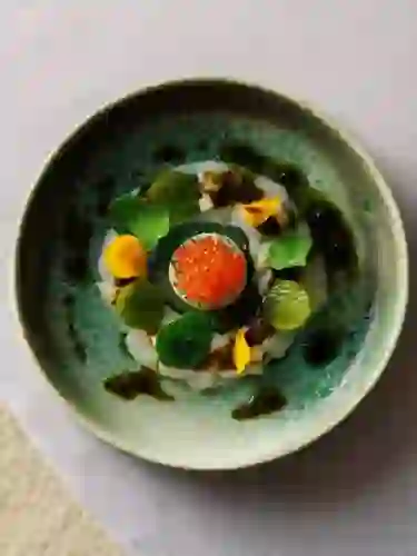 Fine dining seafood dish with edible flowers and roe served in a ceramic bowl at Gregans Castle Hotel, County Clare.