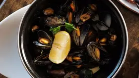 Fresh seafood spread at Monk's, County Clare, with oysters, mussels, crab and brown bread served on a rustic table.