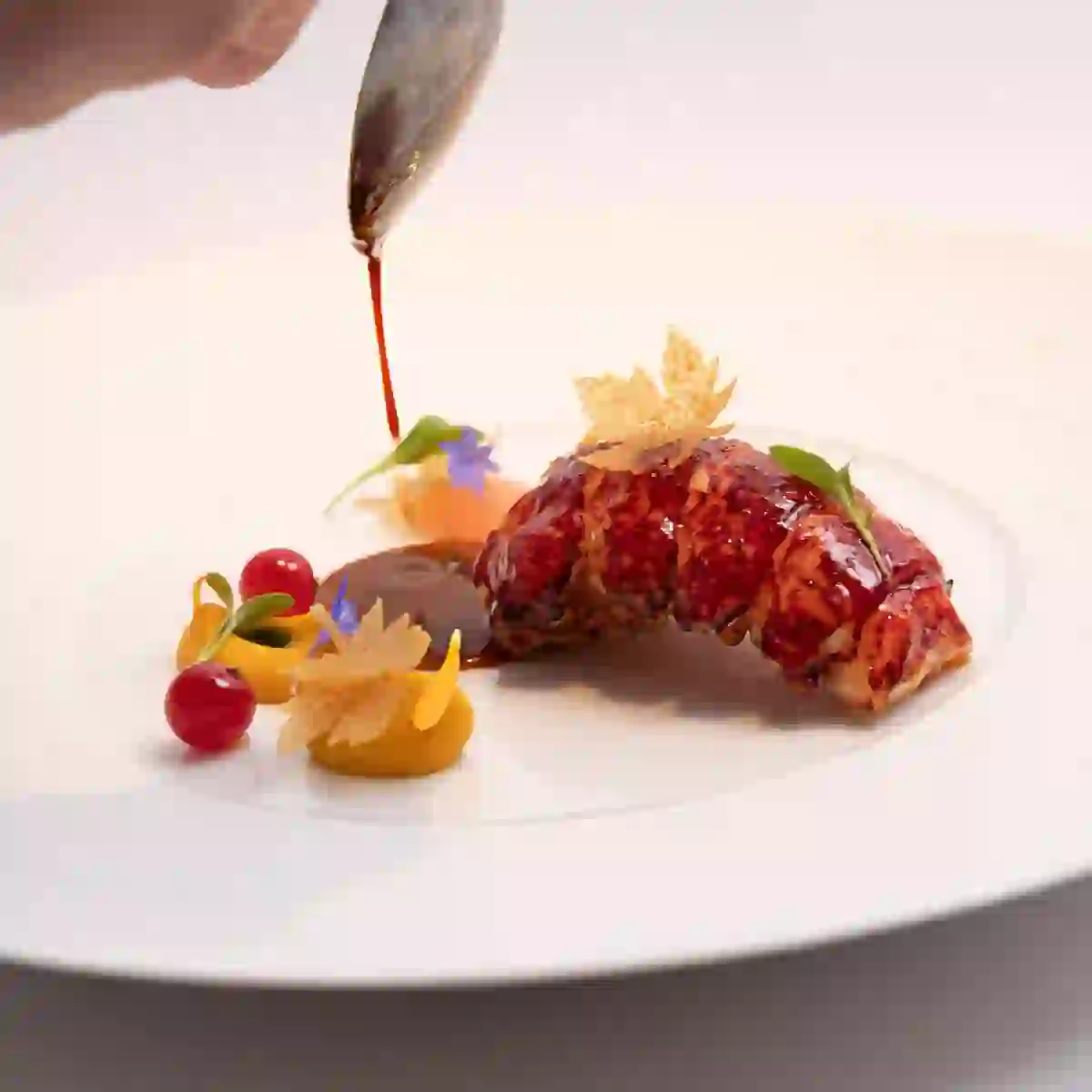 Lobster dish at Chapter One in Dublin, elegantly plated with seasonal garnishes and rich sauce.