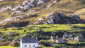 Traditional cottage and rugged coastal landscape on the Wild Atlantic Way in County Donegal.