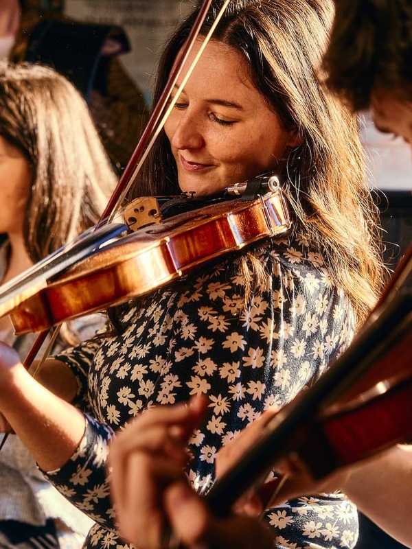 Traditional Irish musicians perform a lively session in a cosy pub in Belfast.