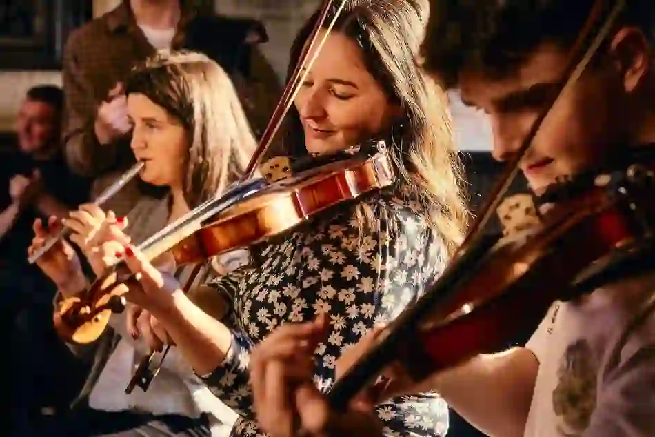 Traditional Irish musicians perform a lively session in a cosy pub in Belfast.