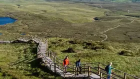 Walkers explore the Cuilcagh Boardwalk Trail amid sweeping upland scenery in County Fermanagh.