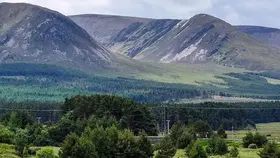 Cyclists cross a bridge on the Great Western Greenway with Croagh Patrick in County Mayo beyond.