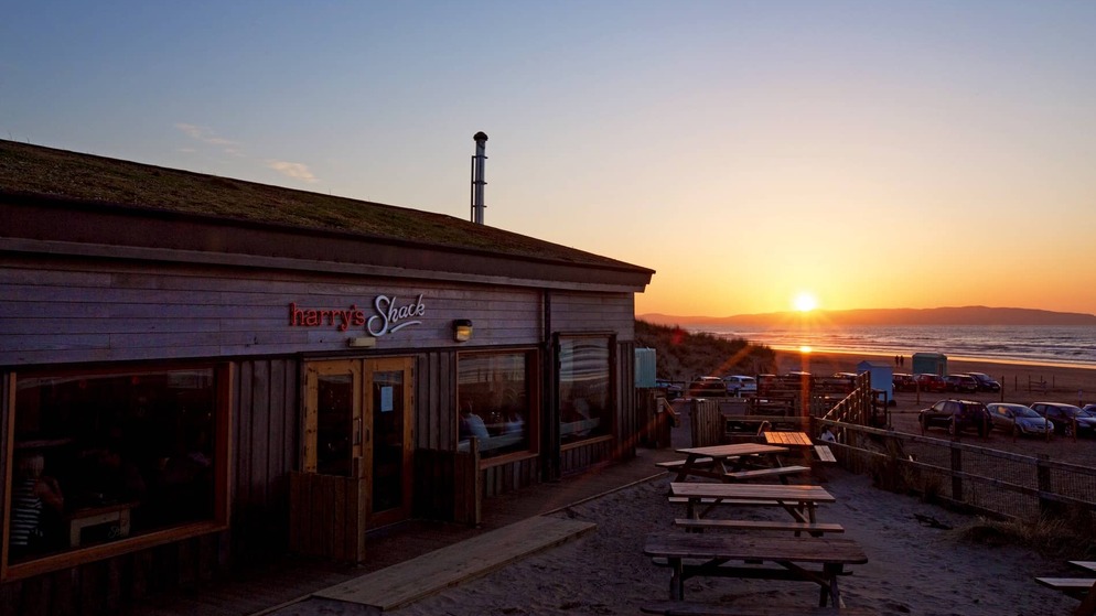 Harry's Shack restaurant overlooking Portstewart Strand at sunset on Northern Ireland's Causeway Coast.