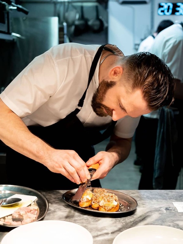 Chef preparing a signature dish at Variety Jones restaurant in Dublin, known for innovative contemporary dining.