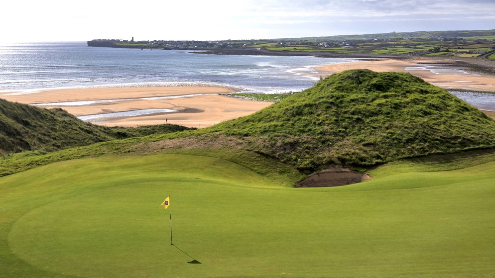 Golf green surrounded by towering sand dunes at Lahinch Golf Club in County Clare.