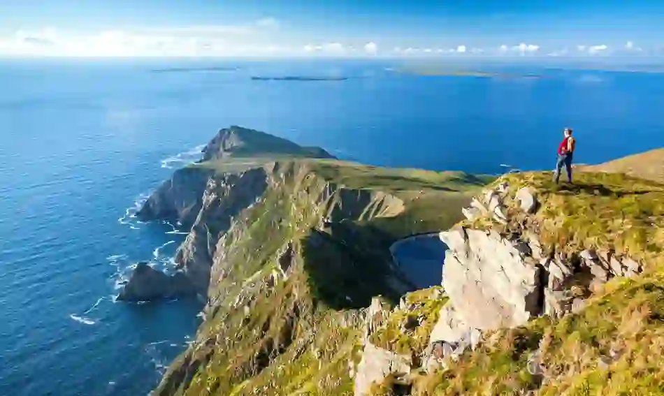 Walker overlooking the cliffs at Saddle Head on Achill Island, County Mayo.