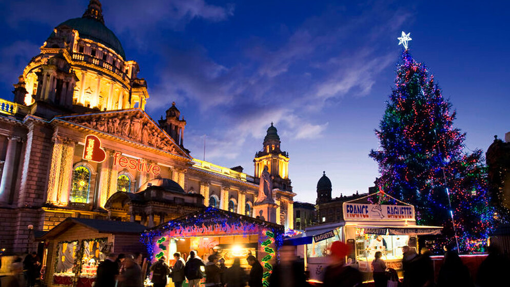 Belfast City Hall lit up with a large Christmas tree at the annual festive market.